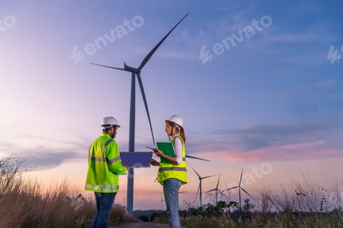Preview: Engineer wearing uniform ,helmet inspection and survey work in wind turbine farms rotation to genera