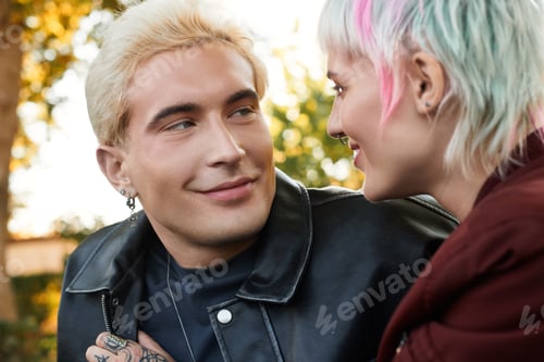 Preview: Young couple sharing a tender moment outdoors on a sunny afternoon