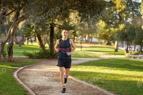 Preview: Man running on park path enjoying healthy lifestyle