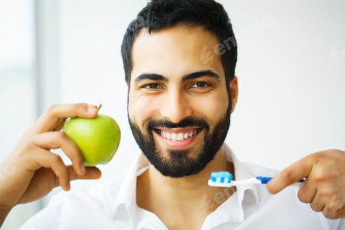 Preview: Beautiful Smiling Man Brushing Healthy White Teeth With Brush. High Resolution Image