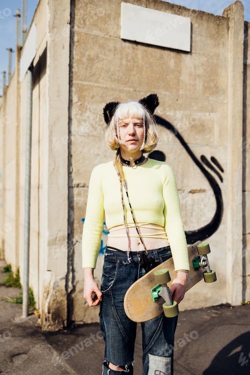 Preview: Gender fluid queer diverse woman skater posing outdoor looking camera serious and confident