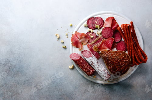 Preview: Cold smoked meat plate. Traditional italian antipasto, cutting board with salami, prosciutto, ham