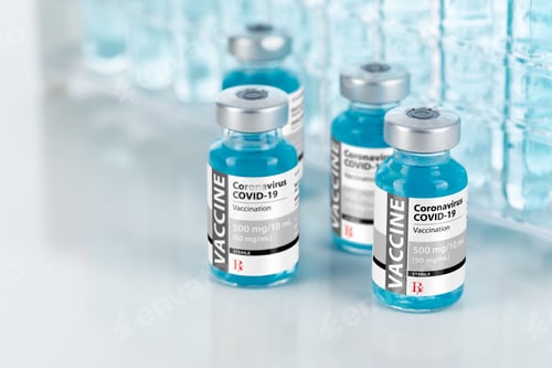 Preview: Coronavirus COVID-19 Vaccine Vials Near Test Tubes On Reflective Surface
