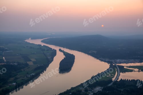 Preview: Aerial view of a river in the valley during smoke covered sky from forest fires