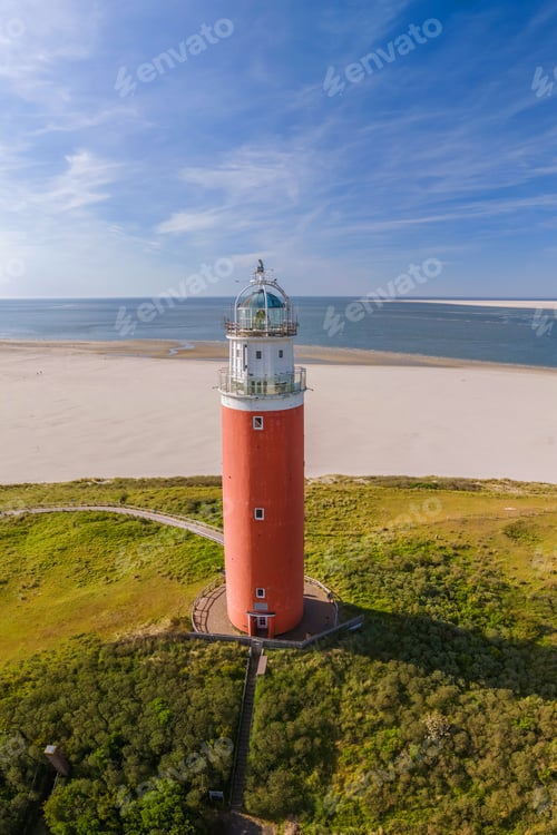 Preview: The iconic red lighthouse of Texel Netherlands, A breathtaking aerial view of a solitary lighthouse