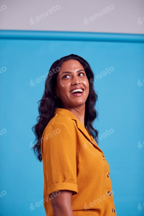 Preview: Portrait Of Mature Female Model Posing For Photographer Against Background On Studio Fashion Shoot