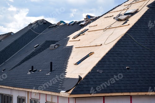 Preview: Closeup installation of black roof shingles on new residential home