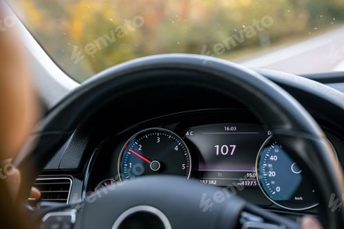 Preview: Steering wheel in a car close up, high speed driving on the road.