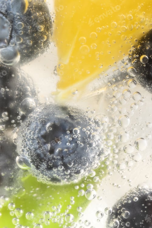 Preview: Closeup shot of a refreshing drink with fresh blueberries and ice cubes