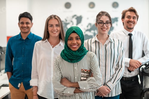 Preview: Portrait of young excited multiethnics business team of software developers standing and looking at