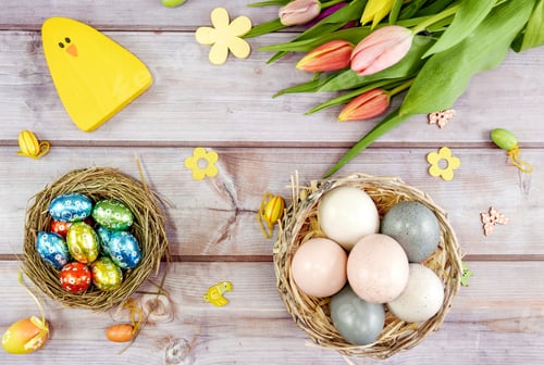 Preview: Easter flat lay. Overhead image of spring flowers, easter eggs and decorations on wooden background.