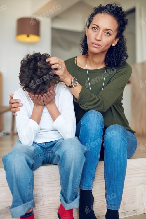 Preview: Ive been trying so hard to cheer him up. Portrait of a mother comforting her little son at home.