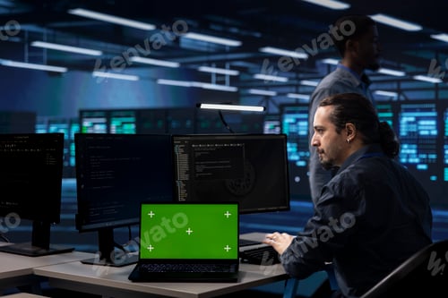 Preview: IT specialist in server hub fixing errors using chroma key notebook