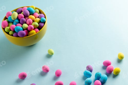 Preview: Image of multi coloured easter eggs in bowl with copy space on blue background