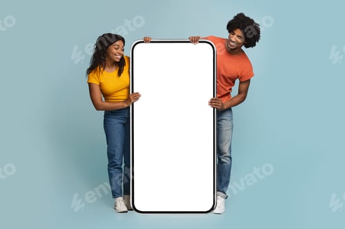 Preview: Curious black lovers looking at huge smartphone with blank screen