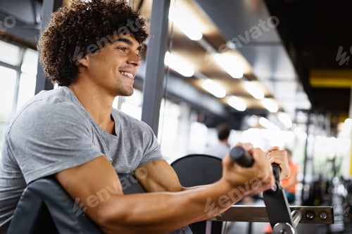 Preview: Muscular bodybuilder handsome man doing exercises in gym. Sport people workout concept