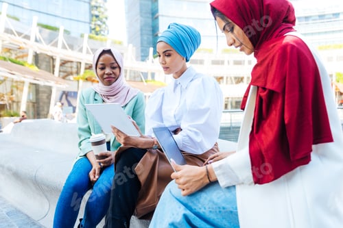 Preview: Beautiful muslim girl wearing hijab bonding outdoors