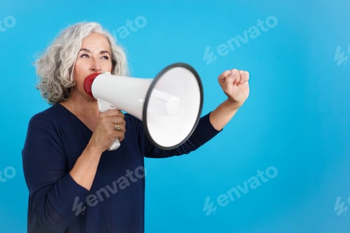 Preview: Angry mature woman protesting with a loudspeaker
