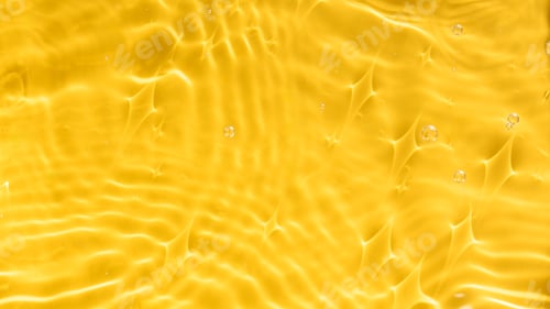 Preview: Abstract background of yellow water with ripples under sunlight. Top view, copy space.