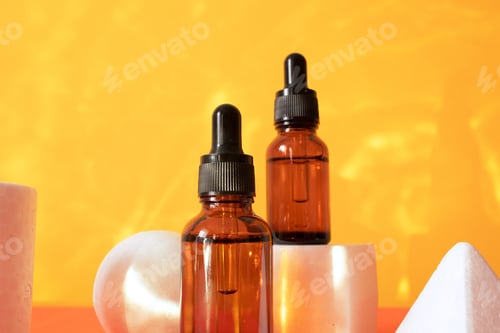 Preview: Glass dropper bottle with a pippette with black rubber tip on the beautiful shadow background.