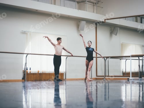 Preview: Man practicing in ballet with partner ballerina woman in black clothing in gym