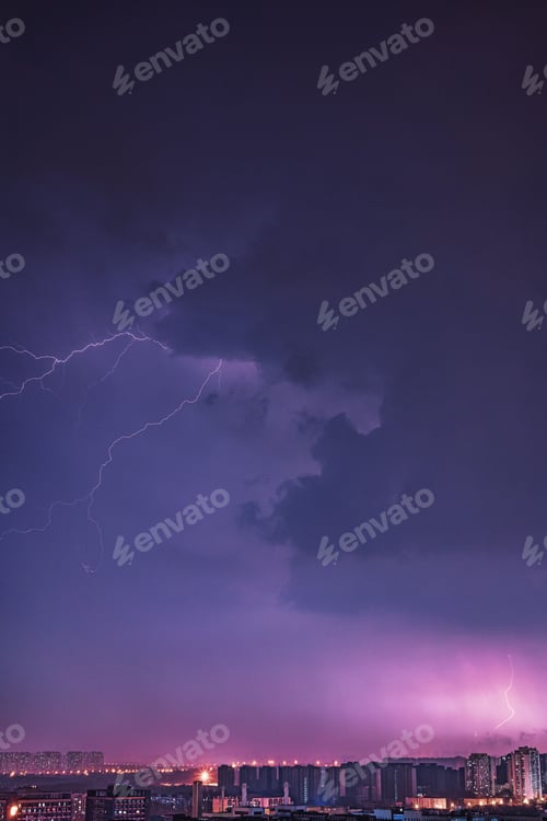 Preview: a lightning bolt strikes through the air above buildings in a city