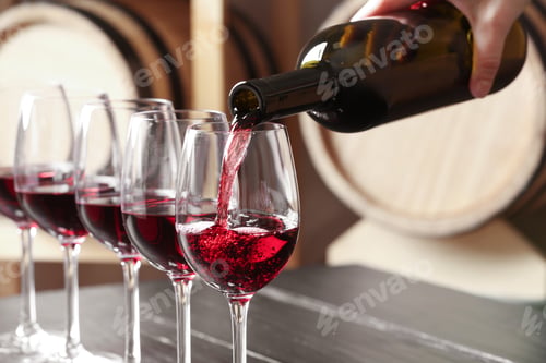 Preview: Woman pouring delicious red wine into glass, closeup