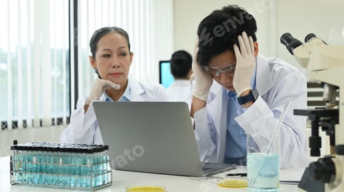 Preview: Professional scientists team conducting experiment in modern laboratory.