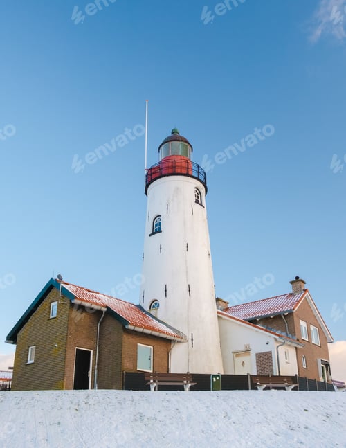 Preview: Lighthouse of Urk during winter in the Netherlands with snow.