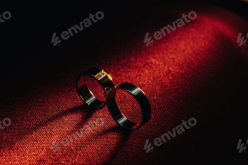 Preview: Two wedding rings on a red background. Gold rings of a couple in love.Concept of love.Wedding ring