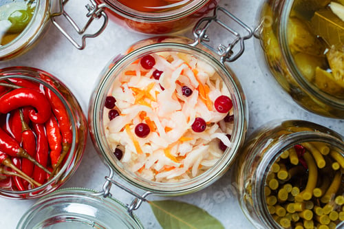 Preview: Sauerkraut with cranberries in a glass jar, top view. Home preservation concept.
