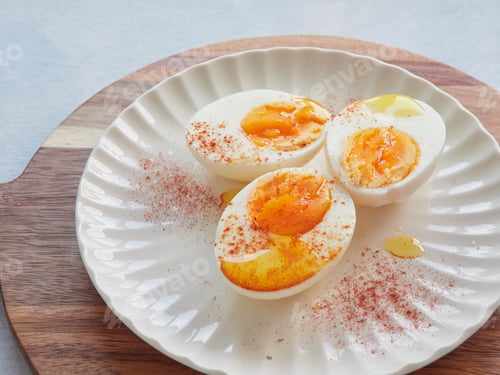 Preview: Healthy and protein food. Hard boiled eggs with olive oil and paprika on top.