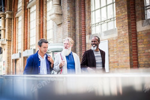 Preview: Three mature men at train station, walking together