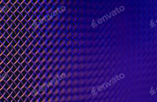 Preview: Metal grill close-up, texture of a music speaker in colored lighting.