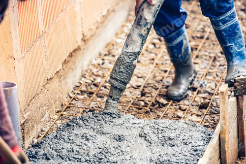 Preview: close up of industrial worker pouring cement or concrete with automatic pump tube