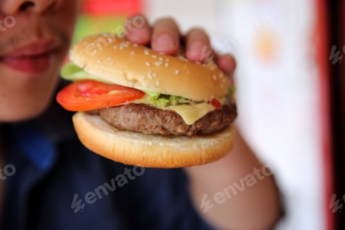 Preview: Beef Hamburger Eating On A Man Hand In Close Up