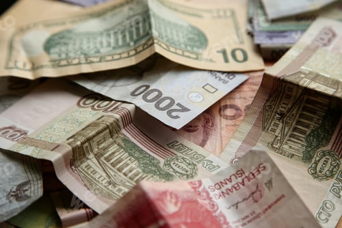 Preview: High angle closeup shot of pile of banknotes on wooden surface