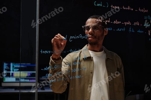 Preview: Businessman Writing on Glass Wall in Modern Office