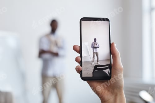 Preview: Hand Holding Smartphone and Taking Photo