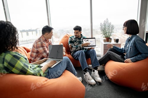Preview: Data analysts looking at laptop with charts in workplace