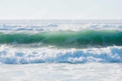 Preview: Seascape with breaking waves on sandy beach.