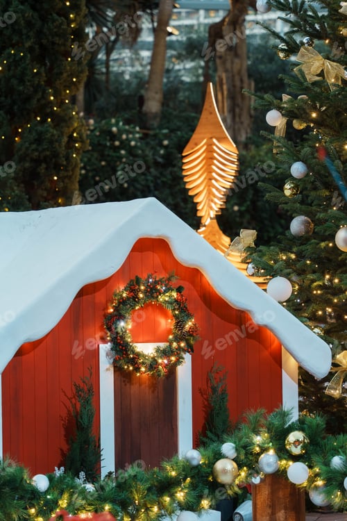 Preview: Cheerful winter scene featuring a snowman in front of a red house