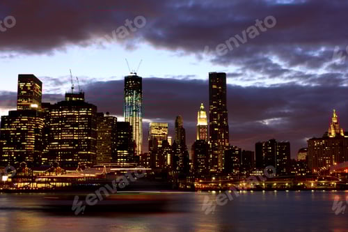 Preview: boat moving at night in against skyline onmanhattan