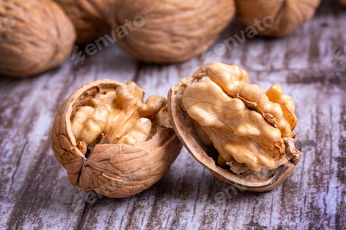 Preview: Walnuts on dark vintage table, Walnuts kernels in wooden bowl. Walnut healthy food