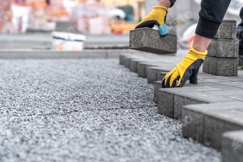 Preview: laying interlocking pavers during the construction of sidewalks and roads. copy space