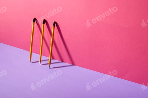 Preview: Composition of pencils standing in row on pink and violet background