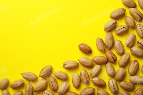 Preview: Tasty pecan nuts on color background, top view. Space for text