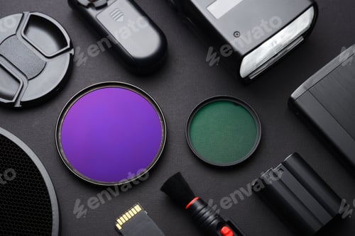 Preview: Top view of work space photographer with accessories on black table background.