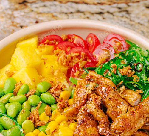 Preview: Vibrant chicken bowl with veggies and tropical fruits in a kitchen