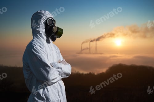 Preview: Scientist in gas mask standing on territory of thermal power plant.
